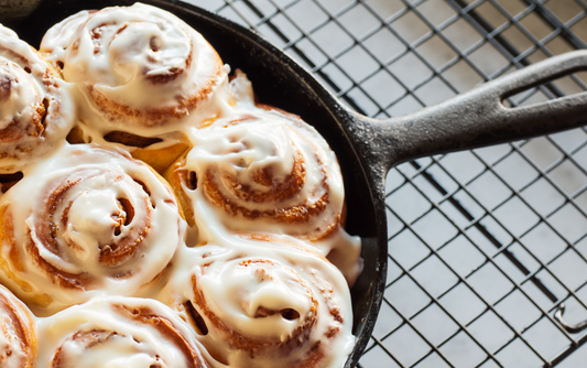 Iced cinnamon rolls baked in cast iron